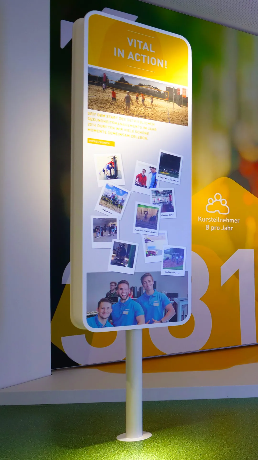 Communication concept for showroom for ABUS crane systems with info stele with collage of team photos and activities, VITAL room as part of the employer brand