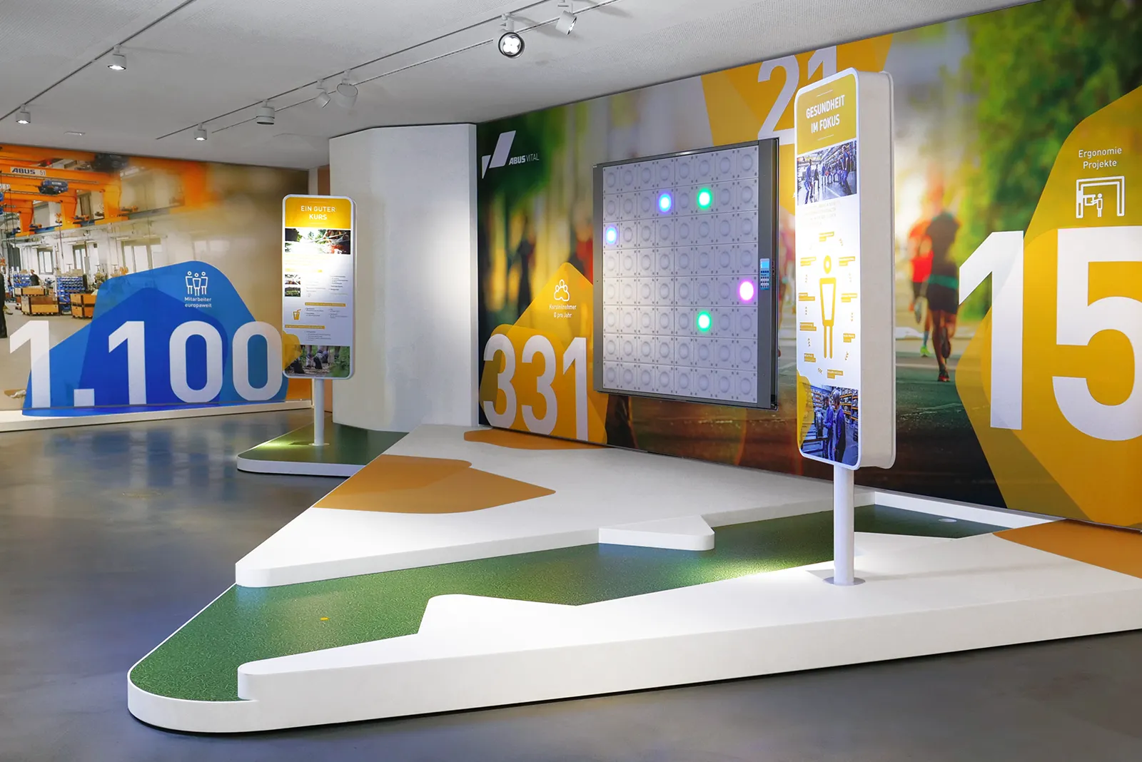 View into the VITAL room at Abus-Kransysteme Showroom with interactive light wall, info steles and wall graphics on health and ergonomics