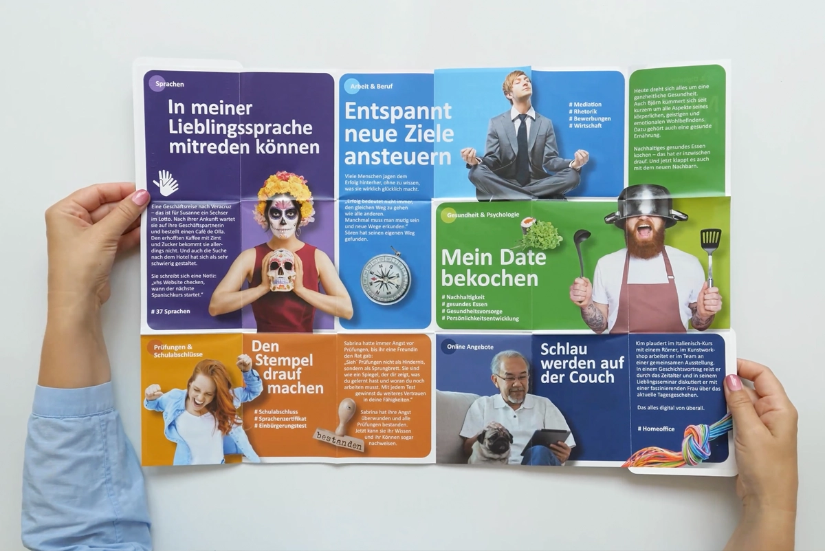 Aufgefalteter Flyer der vhs-Kampagne mit bunten Motiven, der die vhs Düsseldorf modern präsentiert